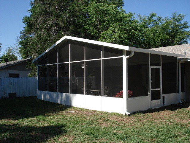 Screened patio enclosure attached to a home built by Southern Construction Pools in Orlando, FL.