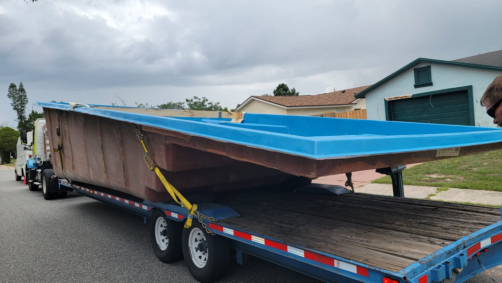 San Juan Wylela Beach fiberglass pool shell on a delivery trailer in Casselberry