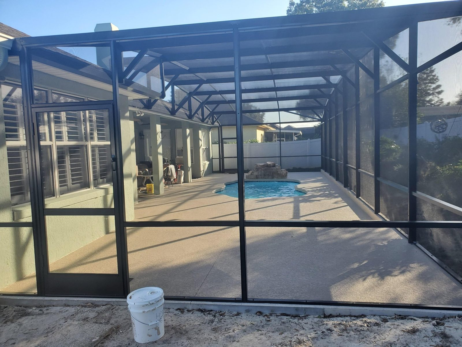Bronze aluminum screen enclosure over a fiberglass pool and lanai