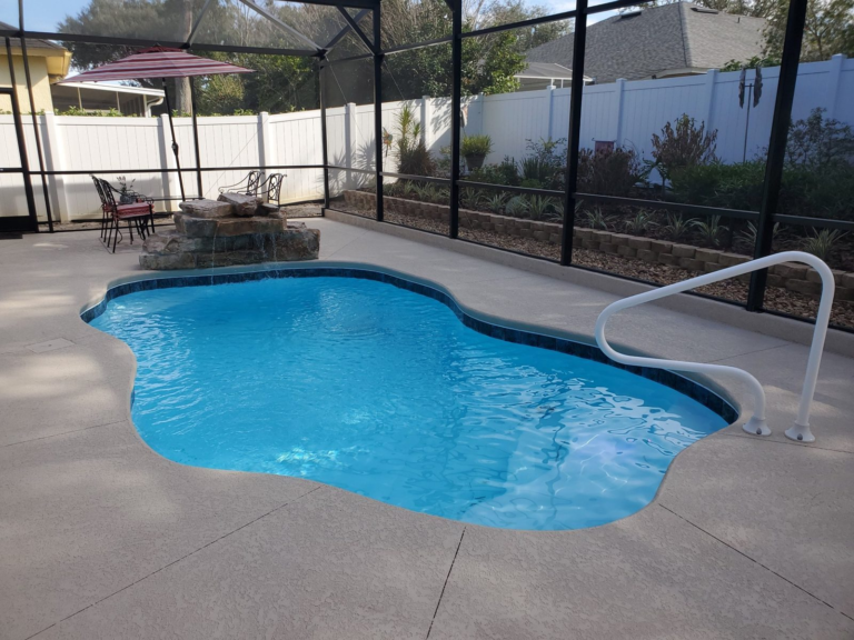 San Juan Ariella fiberglass pool with a Rico Rock waterfall inside a bronze screen enclosure in DeBary