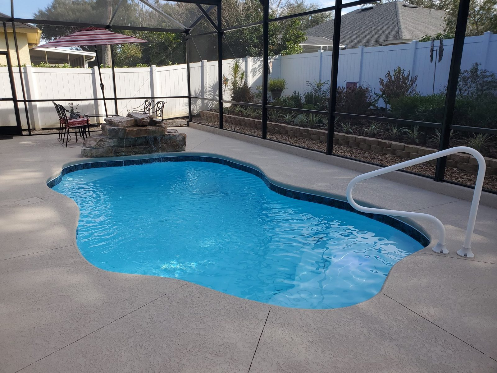 San Juan Ariella fiberglass pool with handrail, waterfall and retaining wall planter
