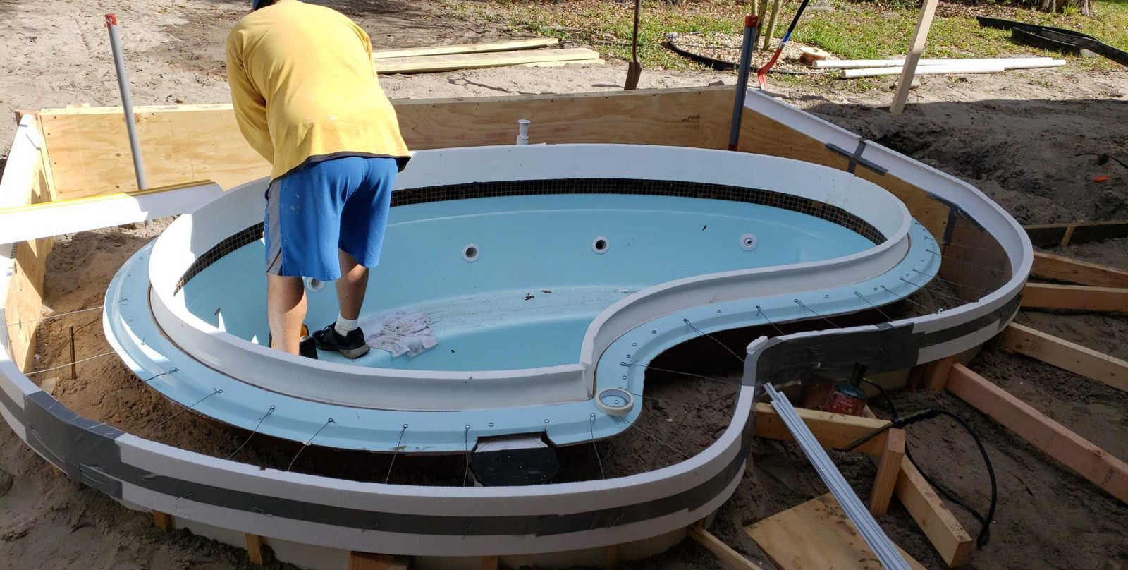 Crew prepping forms around a raised spa shell