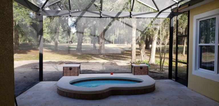 MegaView screen enclosure over a raised spa on a DeLand golf course lot