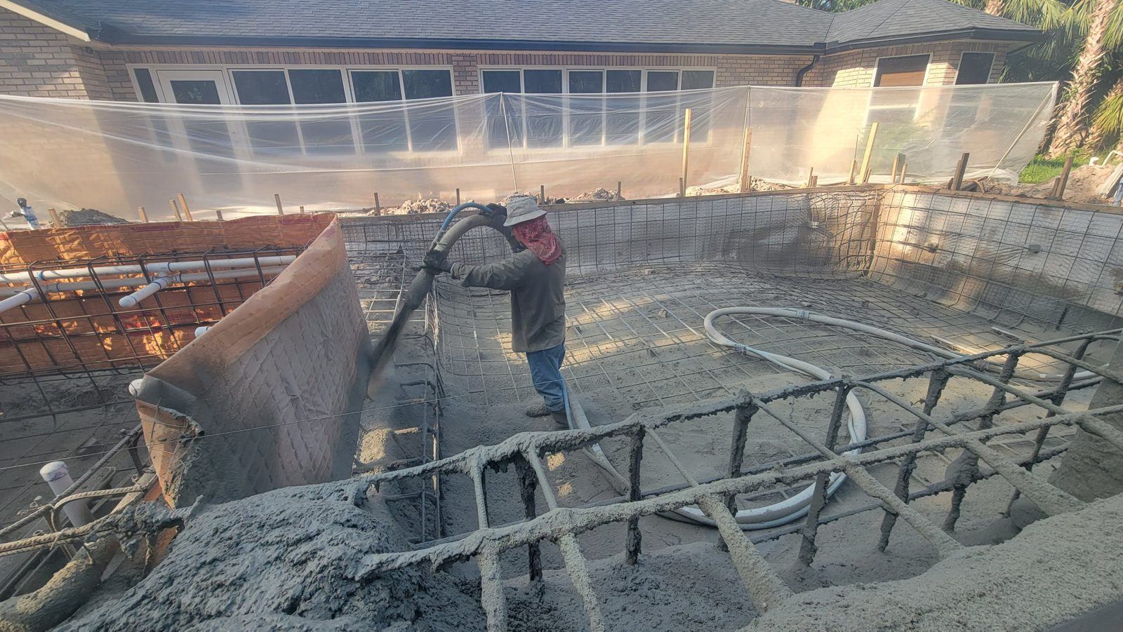 Crew shooting gunite for a custom concrete pool in Deltona, Florida