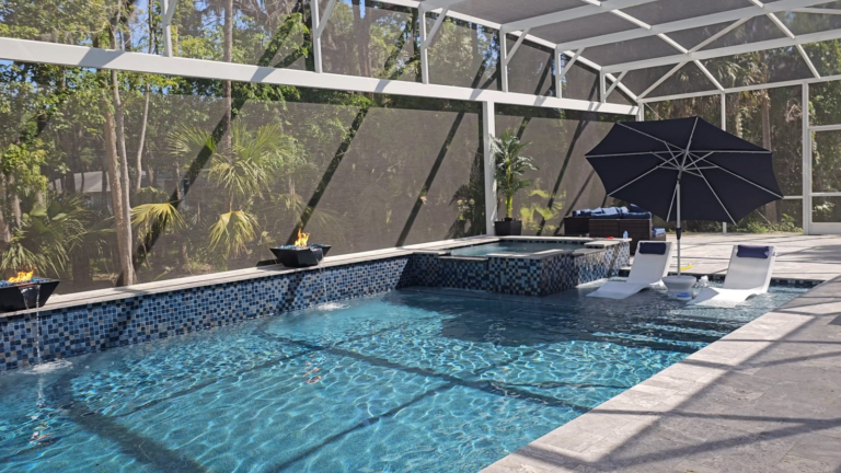 Custom gunite pool with fire and water bowls, raised spa and MegaView screen enclosure in Deltona
