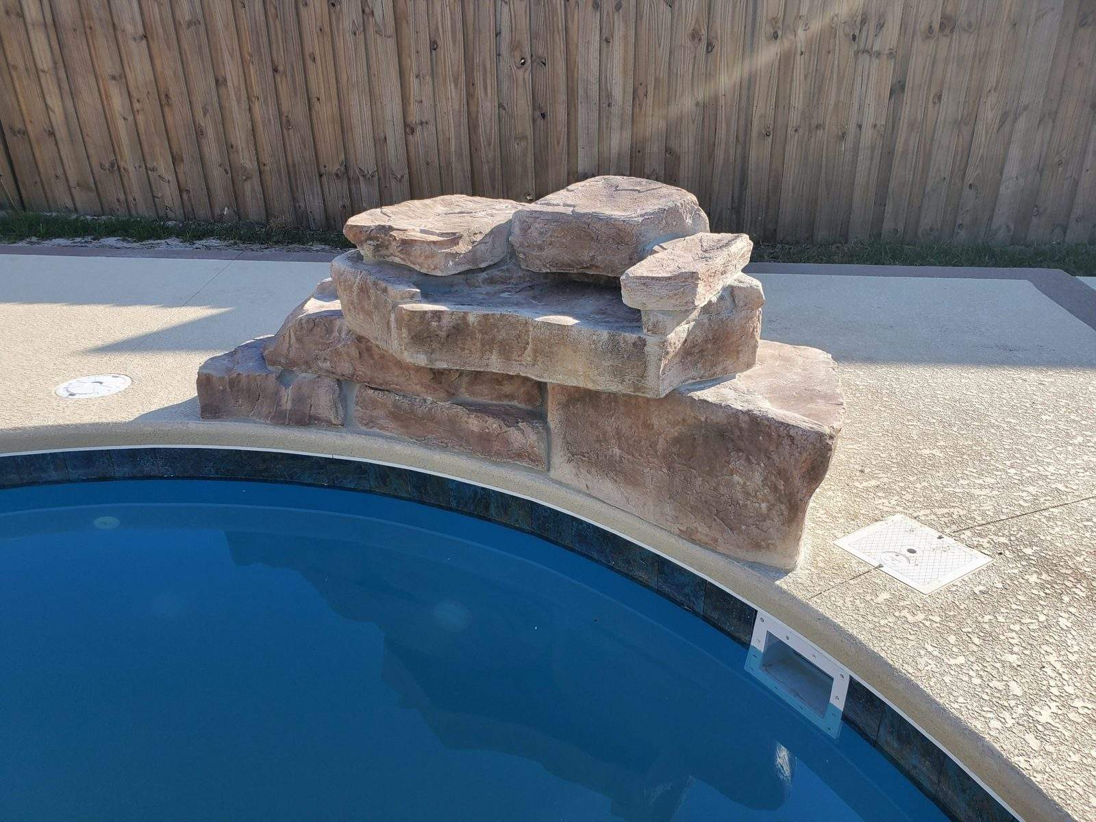 Rico Rock waterfall set beside a fiberglass pool