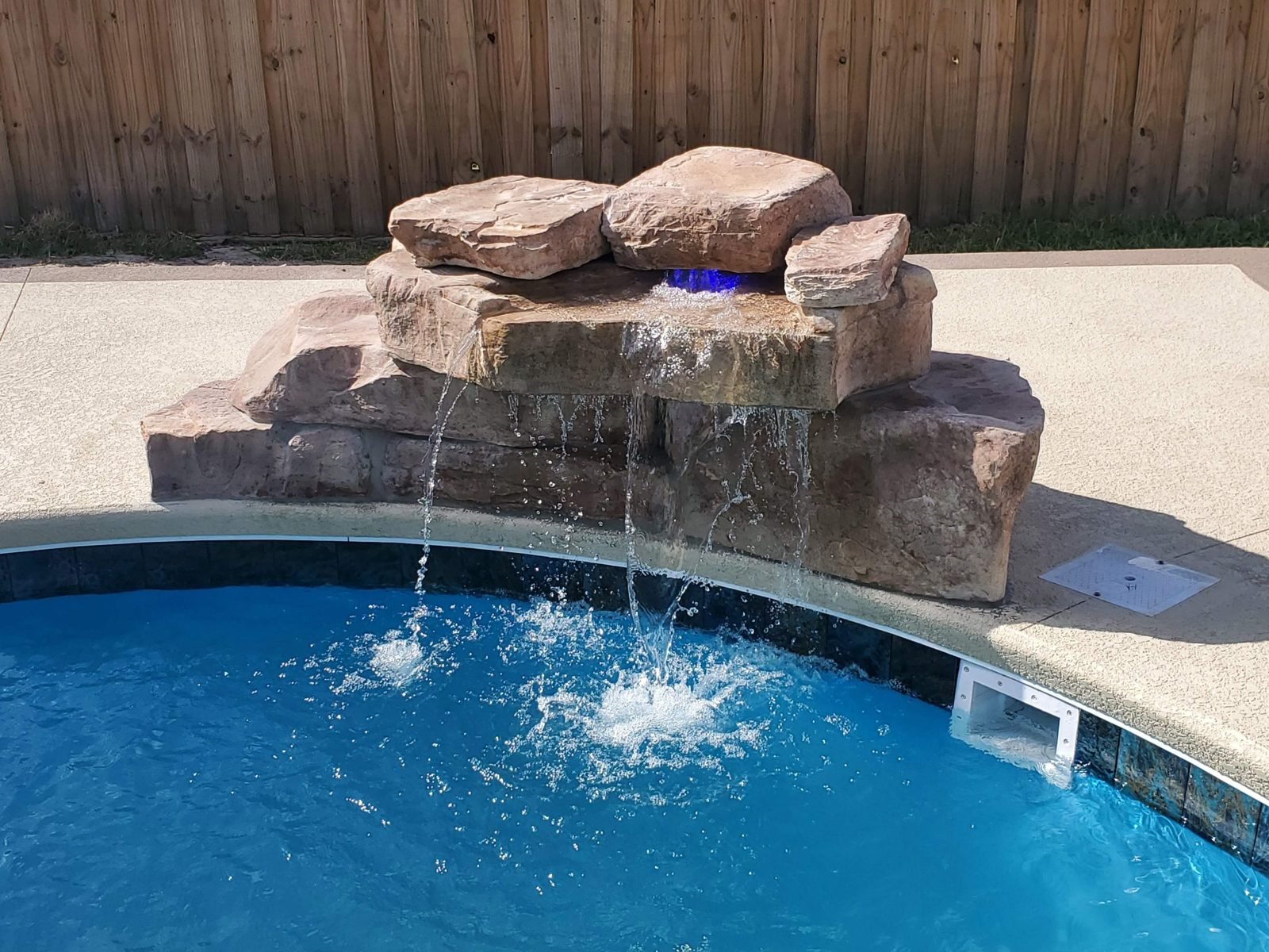 Rico Rock waterfall with a blue LED light flowing into a pool