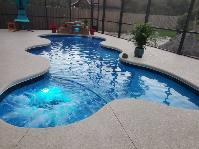 San Juan Desert Springs fiberglass pool and spa with a Rico Rock waterfall and LED lights in Deltona