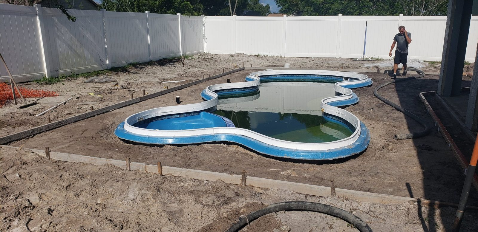 Cantilever concrete deck forms around a fiberglass pool